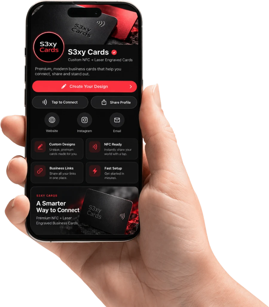 A hand holding a phone that shows a S3XY Profile: the S3xy Cards name and logo, buttons for Create Your Design, Tap to Connect and Share Profile, and links to a website, Instagram and email